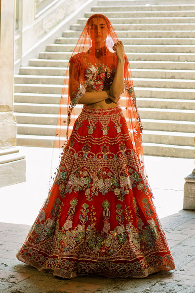 Embellished motifs detail on right waist of red lehenga