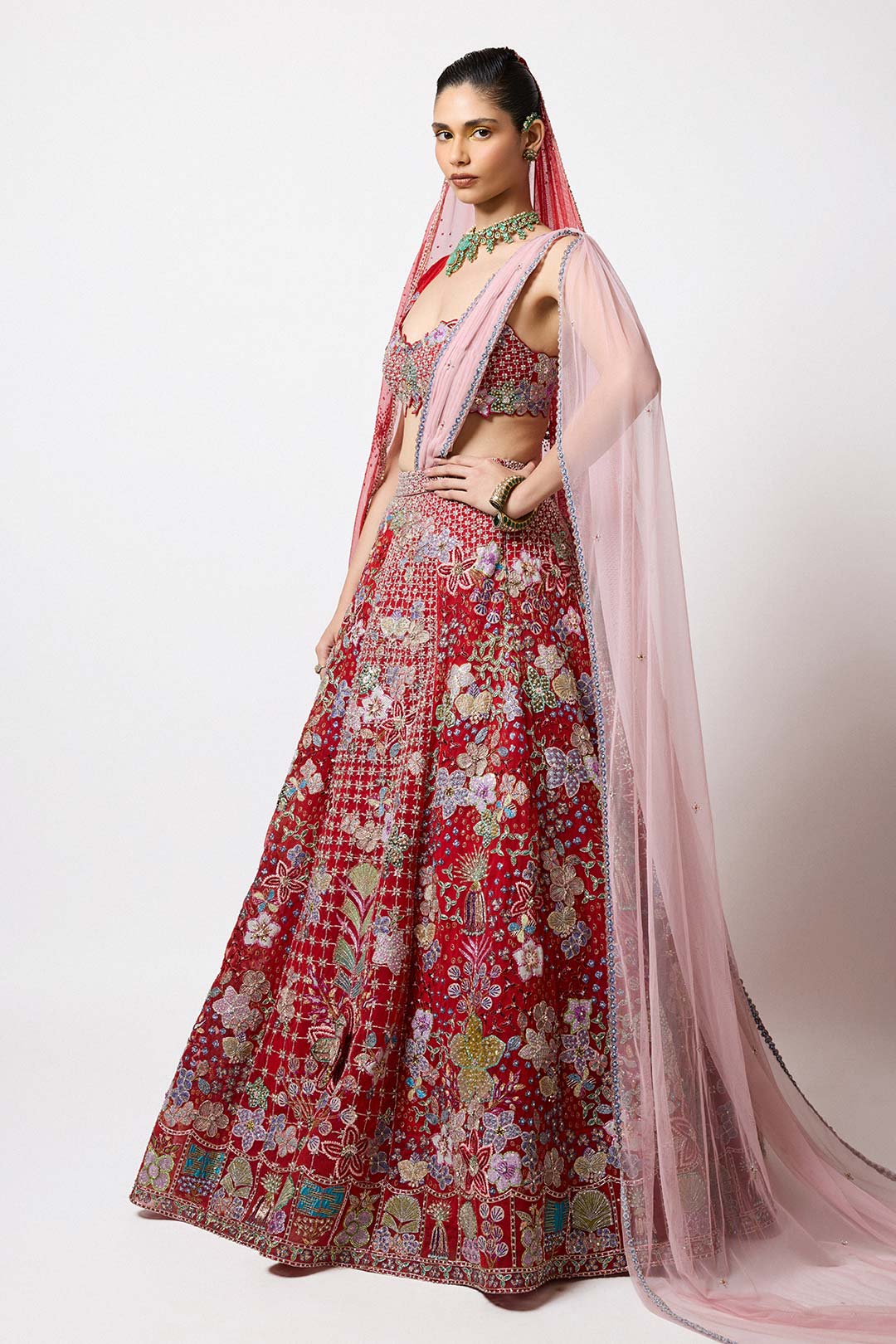 Woman in red tulle lehenga side profile with applique
