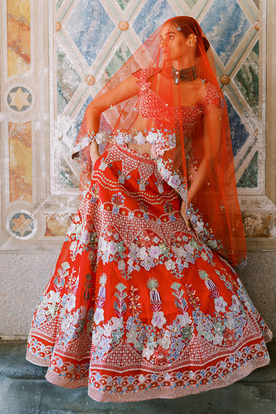 Model in red embellished lehenga by Aisha Rao, tulle dupatta styled