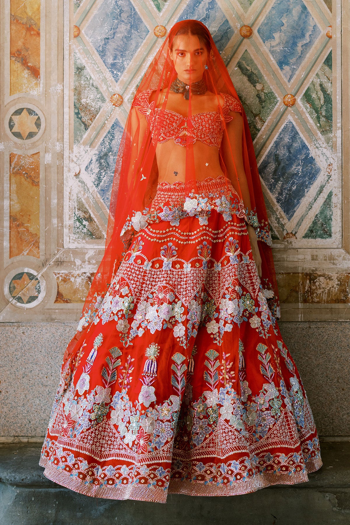 Woman wearing Aisha Rao red raw silk lehenga with applique embroidery
