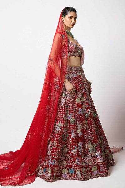 Woman wearing Aisha Rao red tulle lehenga with 3D flowers