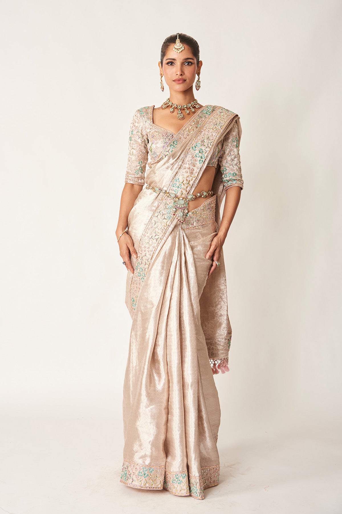 Woman in rose champagne Banarasi brocade saree
