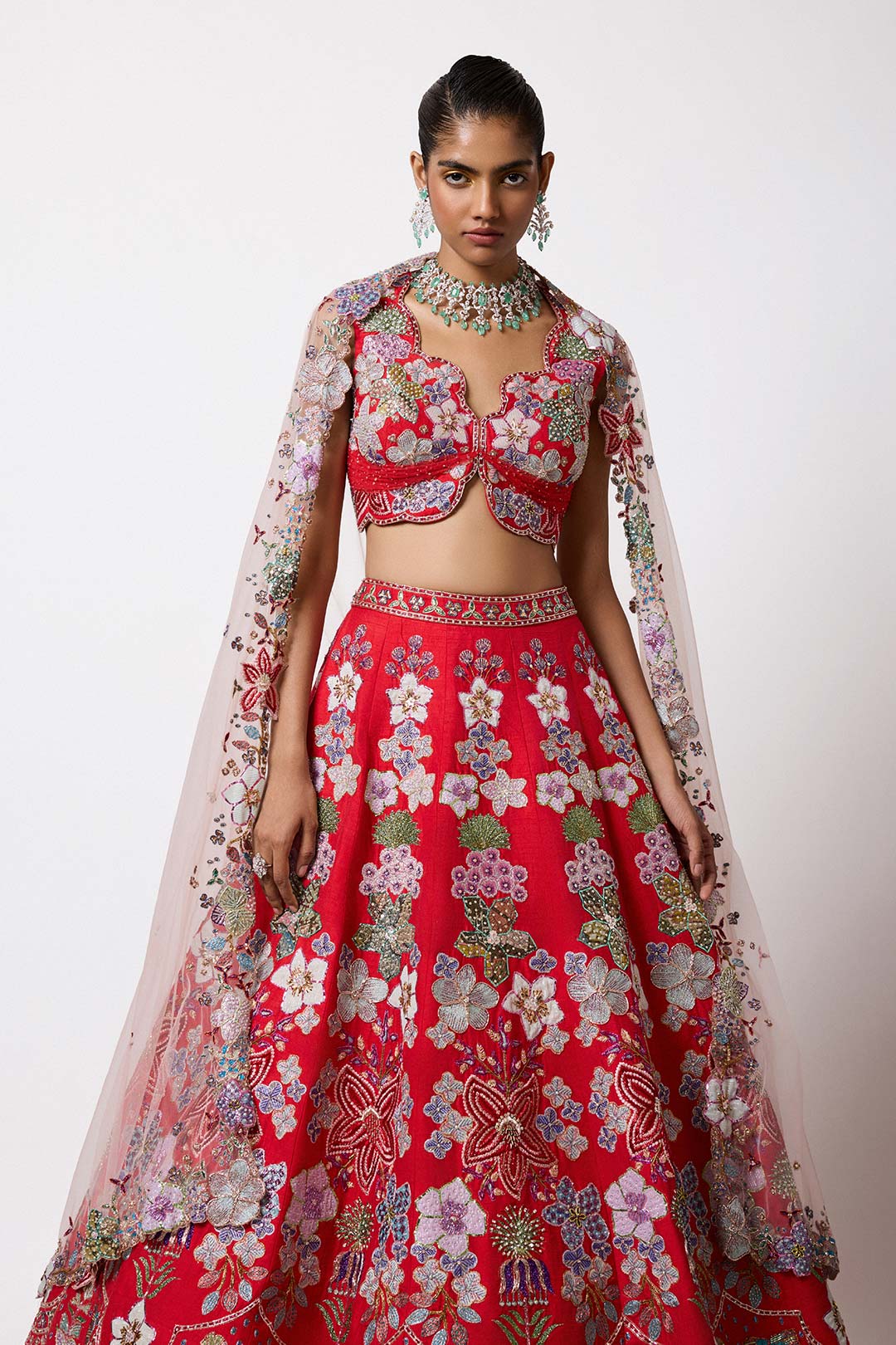 Woman in red HK lehenga with applique right profile