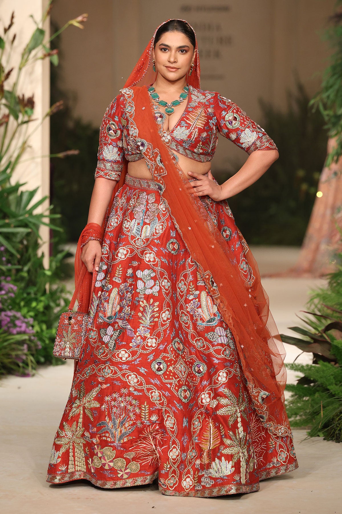Tulle dupatta drape shot paired with the Wild At Heart rust raw silk lehenga.