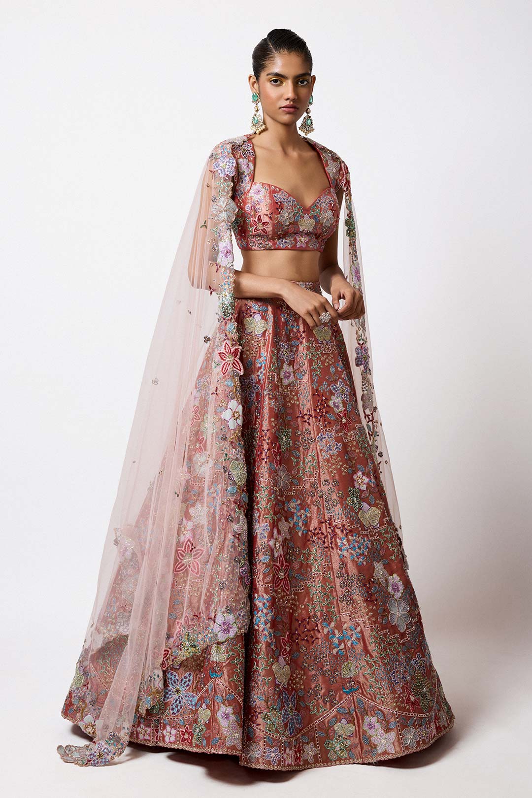 Woman wearing Aisha Rao rust red tissue applique lehenga