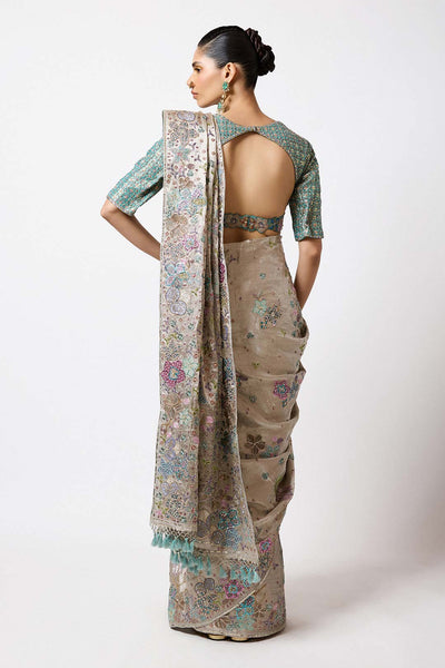 Woman in Aisha Rao silver applique outfit left profile