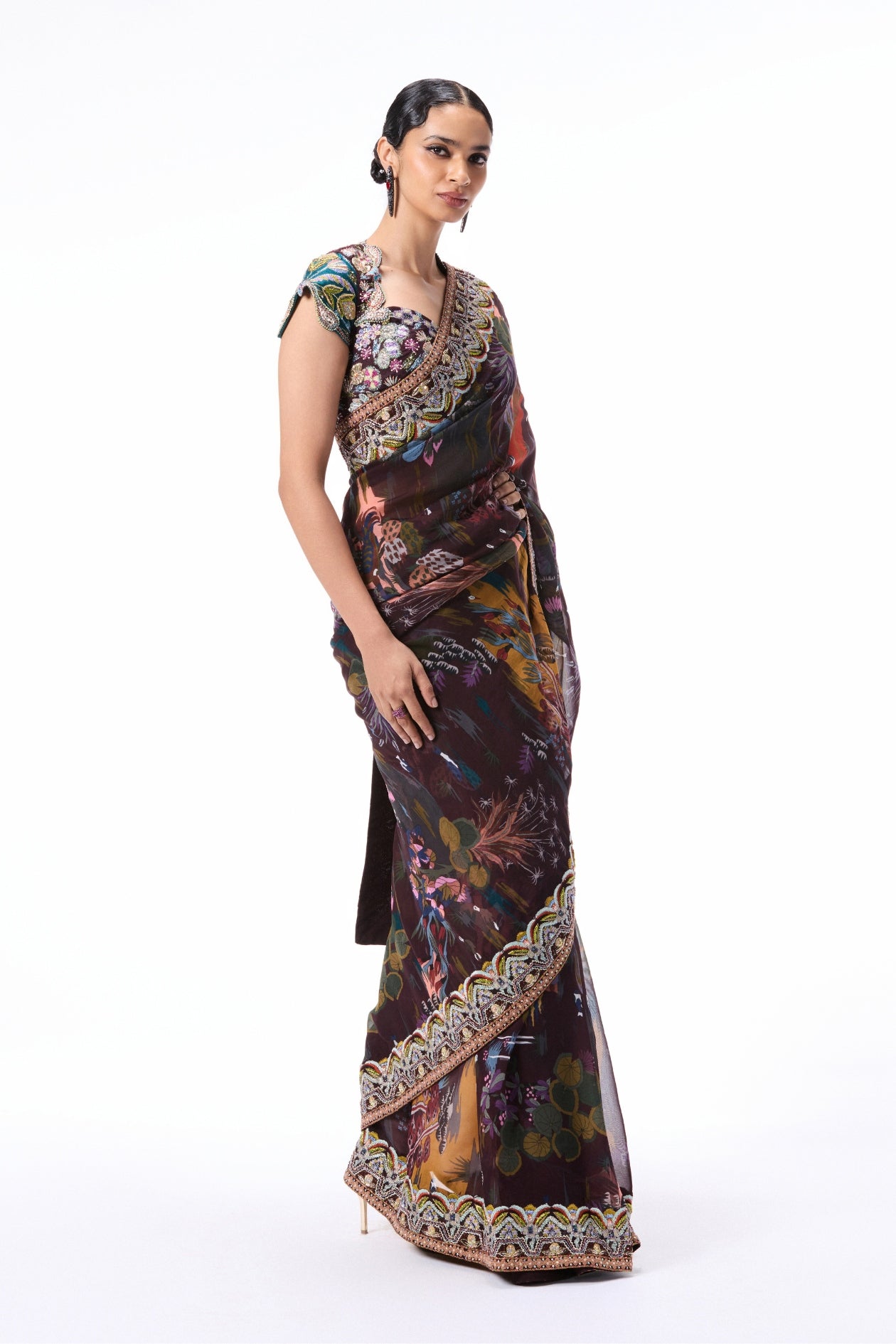 Styled look of the raw silk blouse paired with the teakberry printed viscose organza saree.