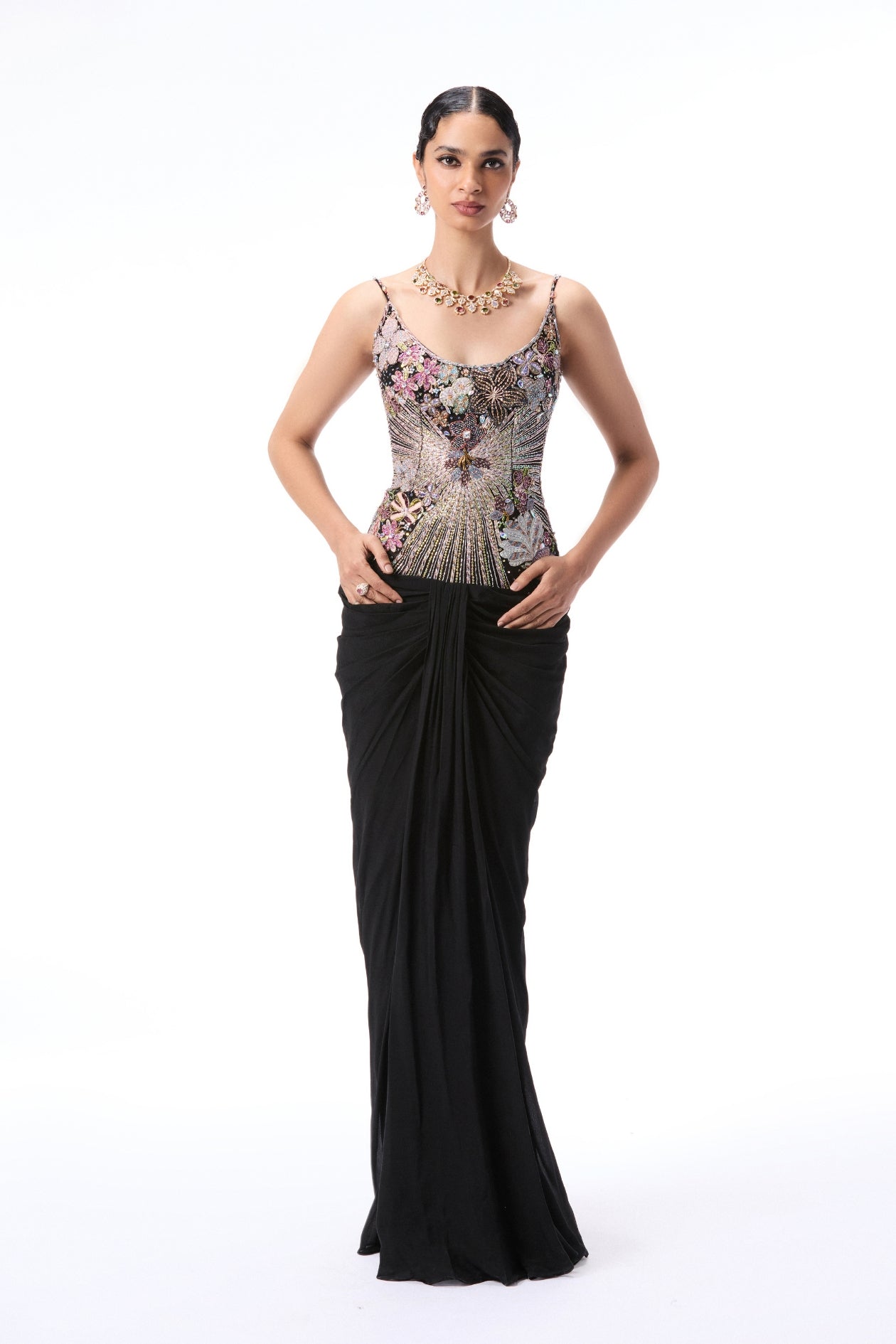 Woman wearing a black evening gown with floral embellishments 