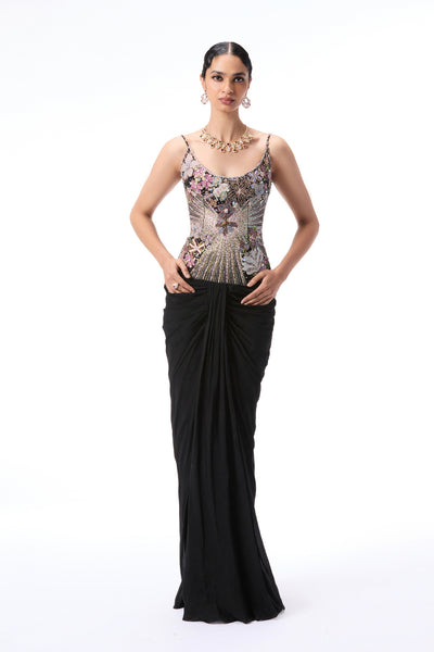 Woman wearing a black evening gown with floral embellishments 