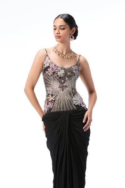 Close-up of intricate applique detailing on black tulle bodice paired with chiffon draped skirt