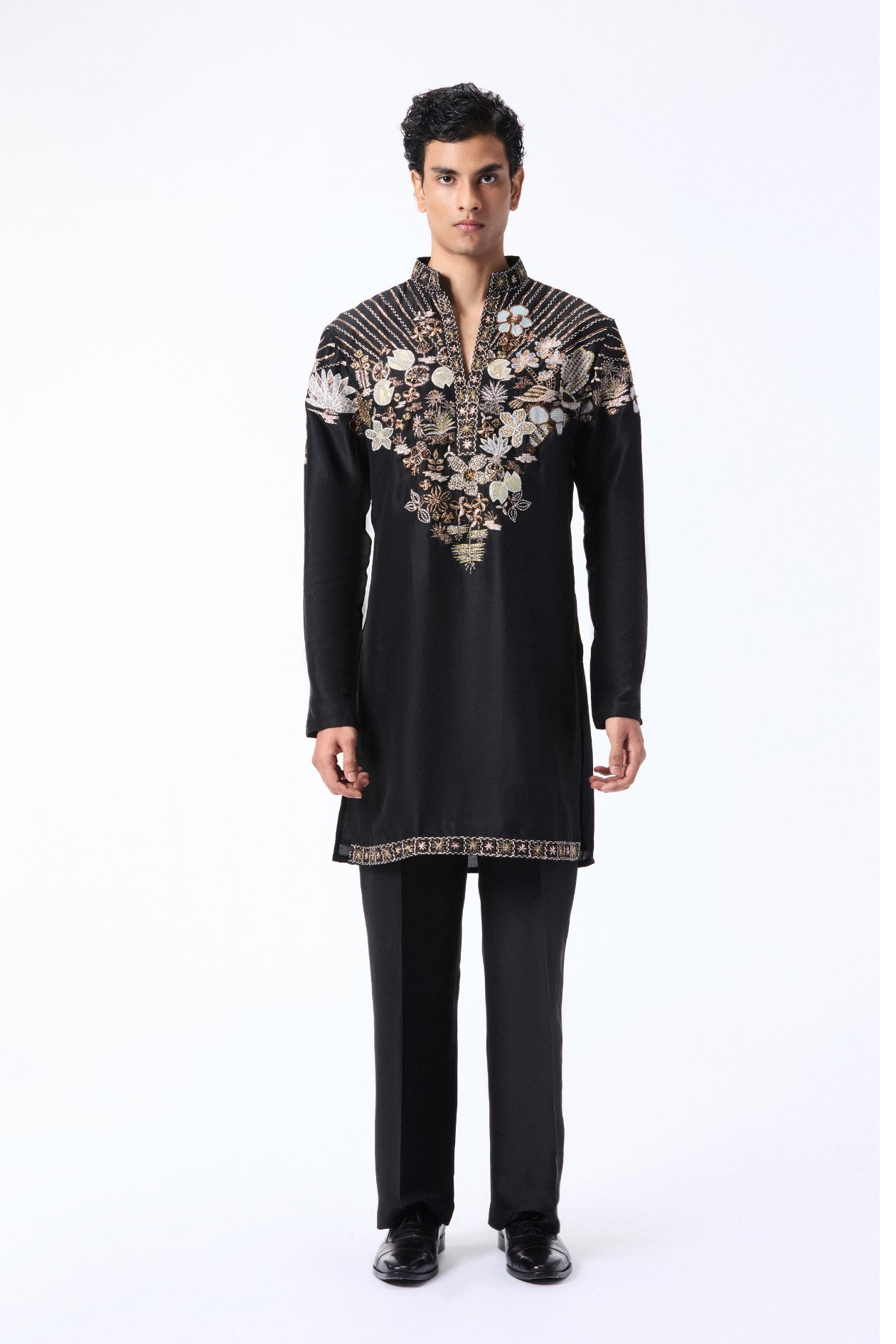 Man wearing a black embroidered kurta with pants