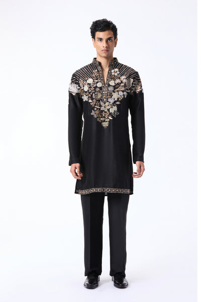 Man wearing a black embroidered kurta with pants
