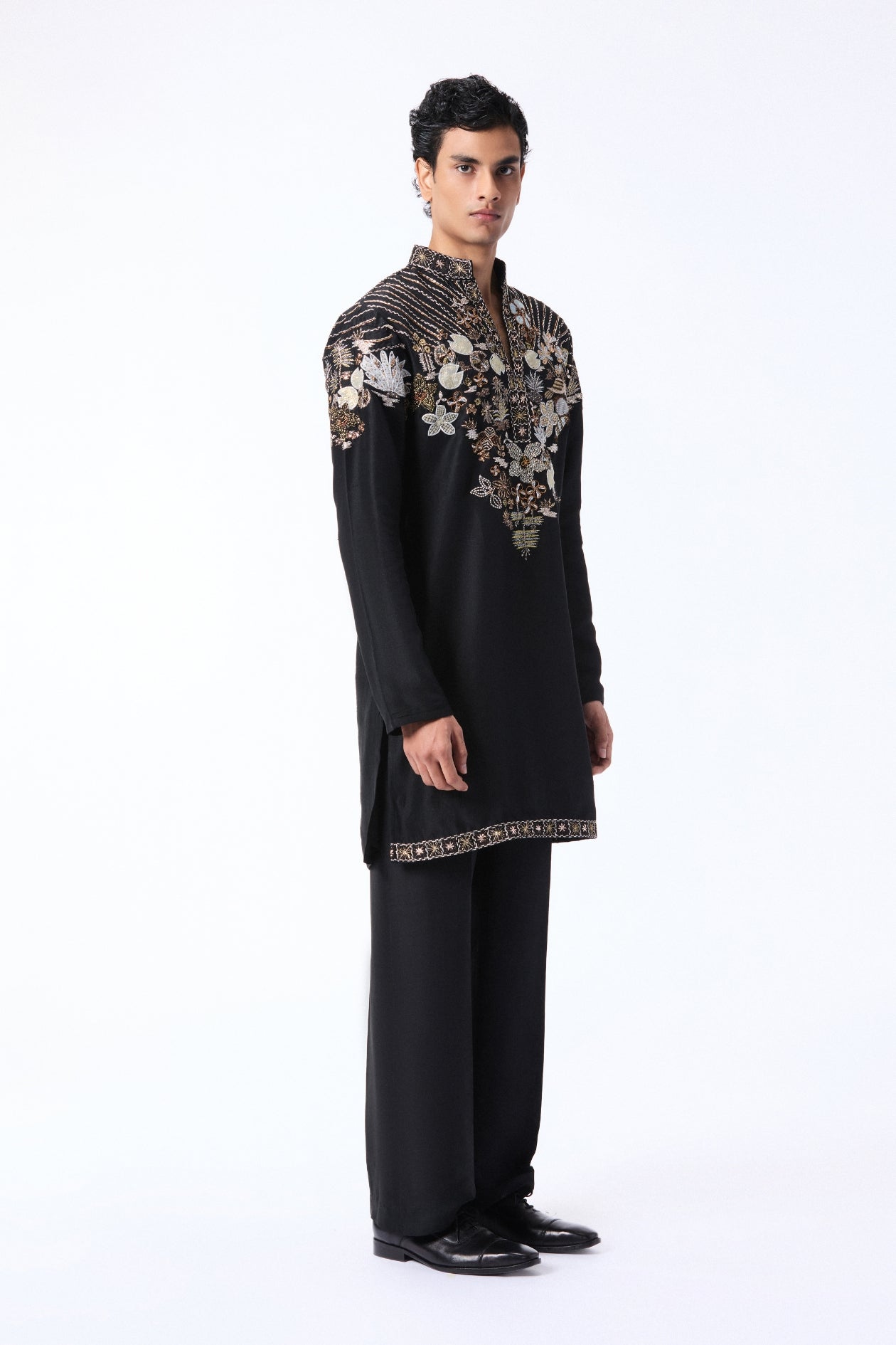 Man wearing a black kurta set with floral embroidery 