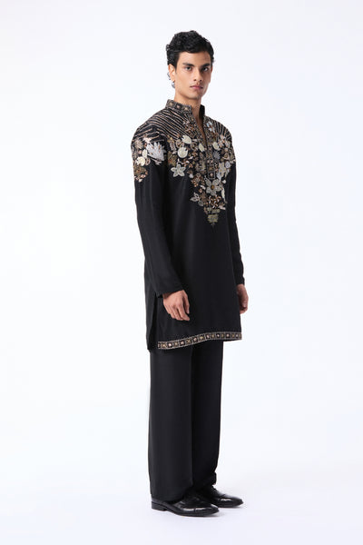 Man wearing a black kurta set with floral embroidery 