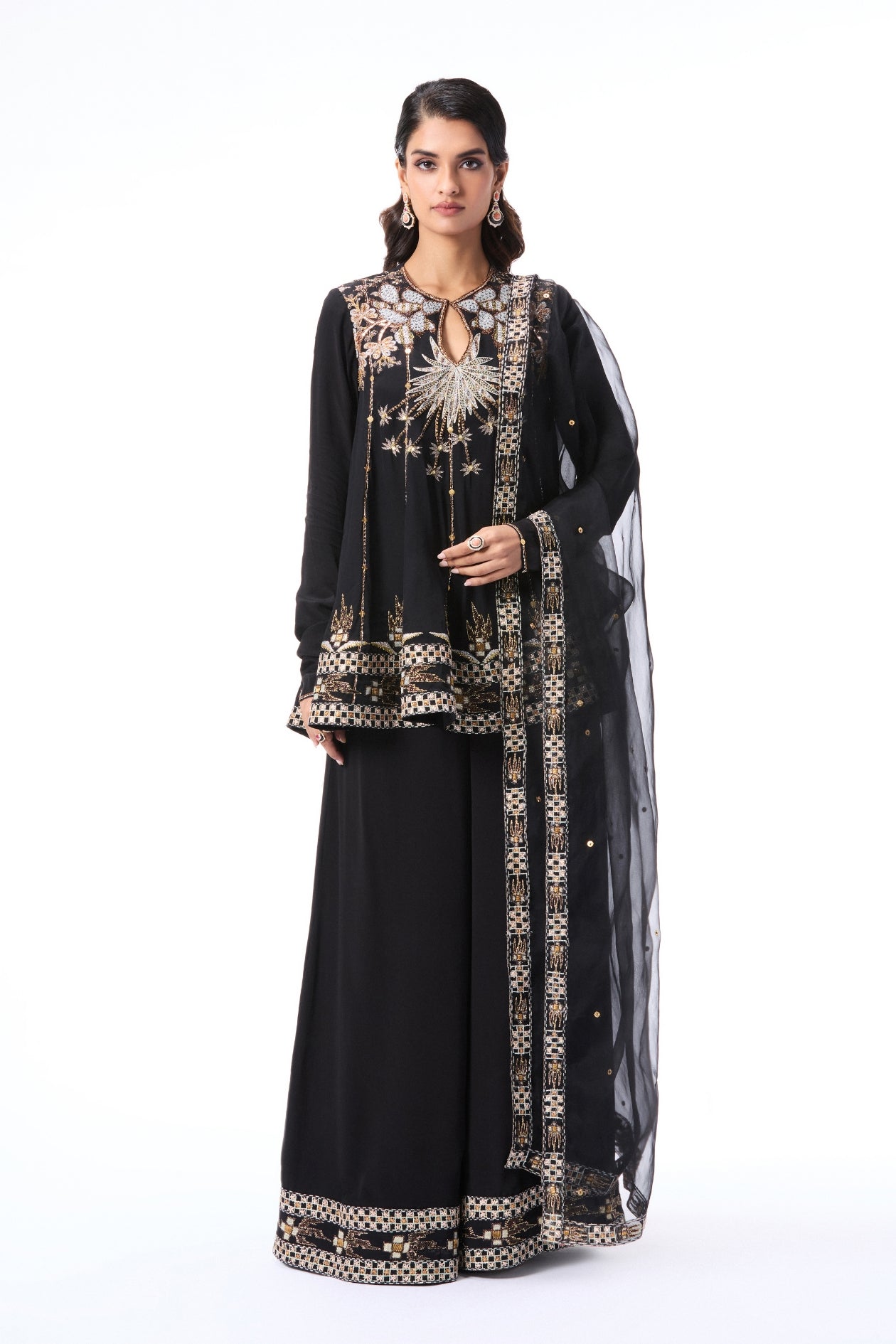 Front view of model in black applique embellished kurta and sharara by Aisha Rao