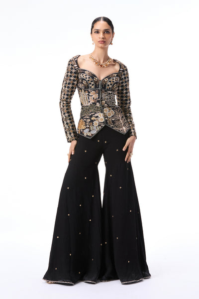 Front view of black applique embellished raw silk top with double georgette gharara pants