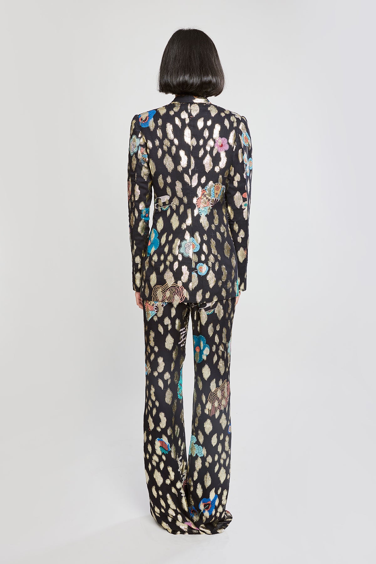 Rear silhouette of black pantsuit ensemble