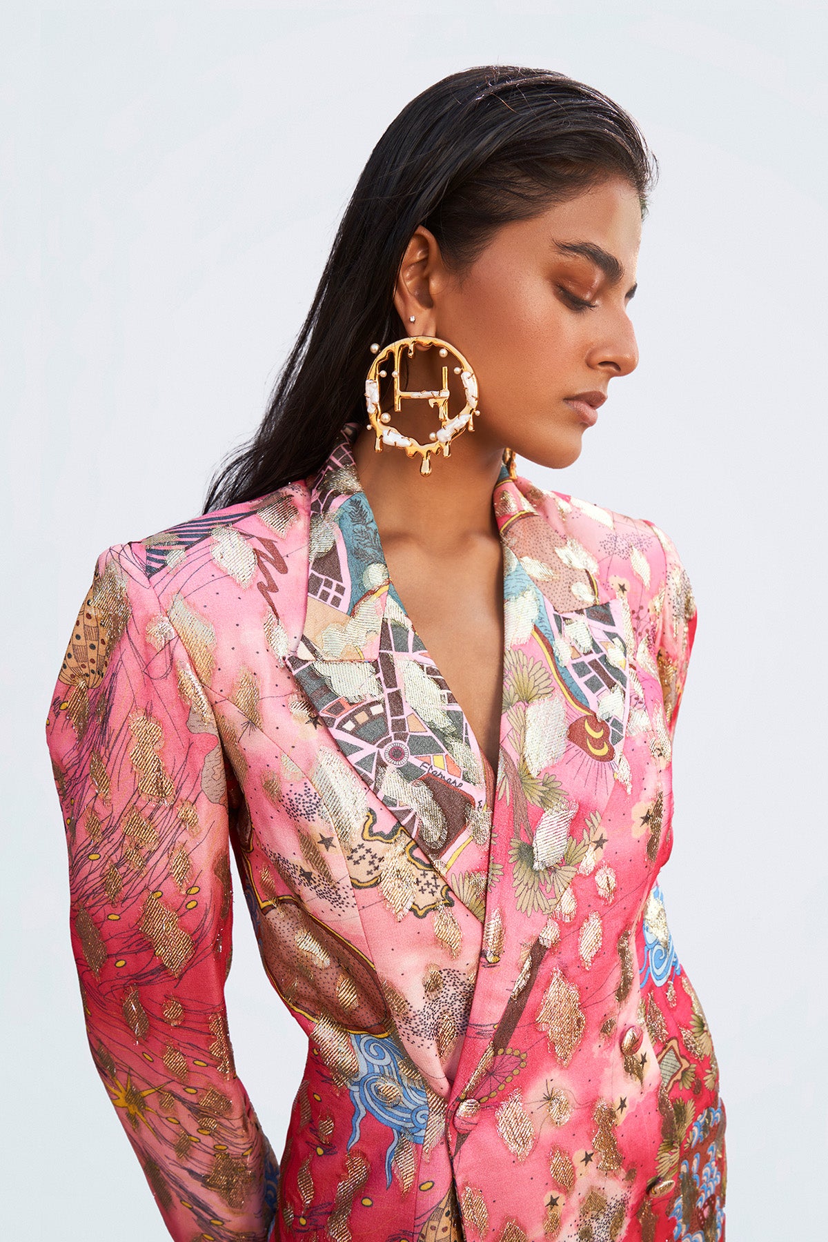 Left profile of printed blazer and trousers set.