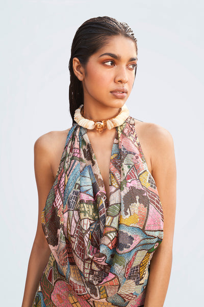Close-up of printed fabric and cowl neckline detail.

