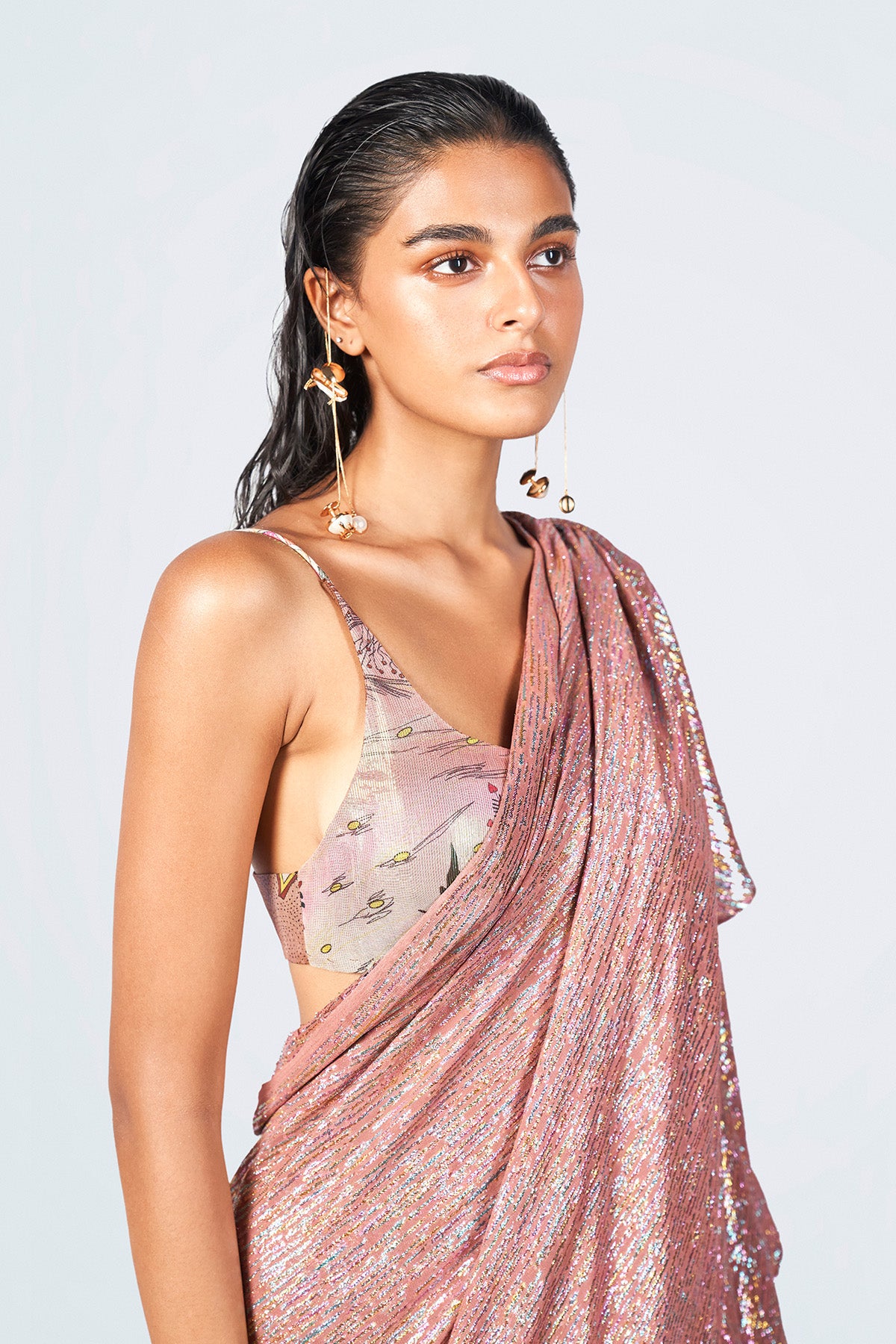 Close-up of lurex fabric texture and blouse print details.

