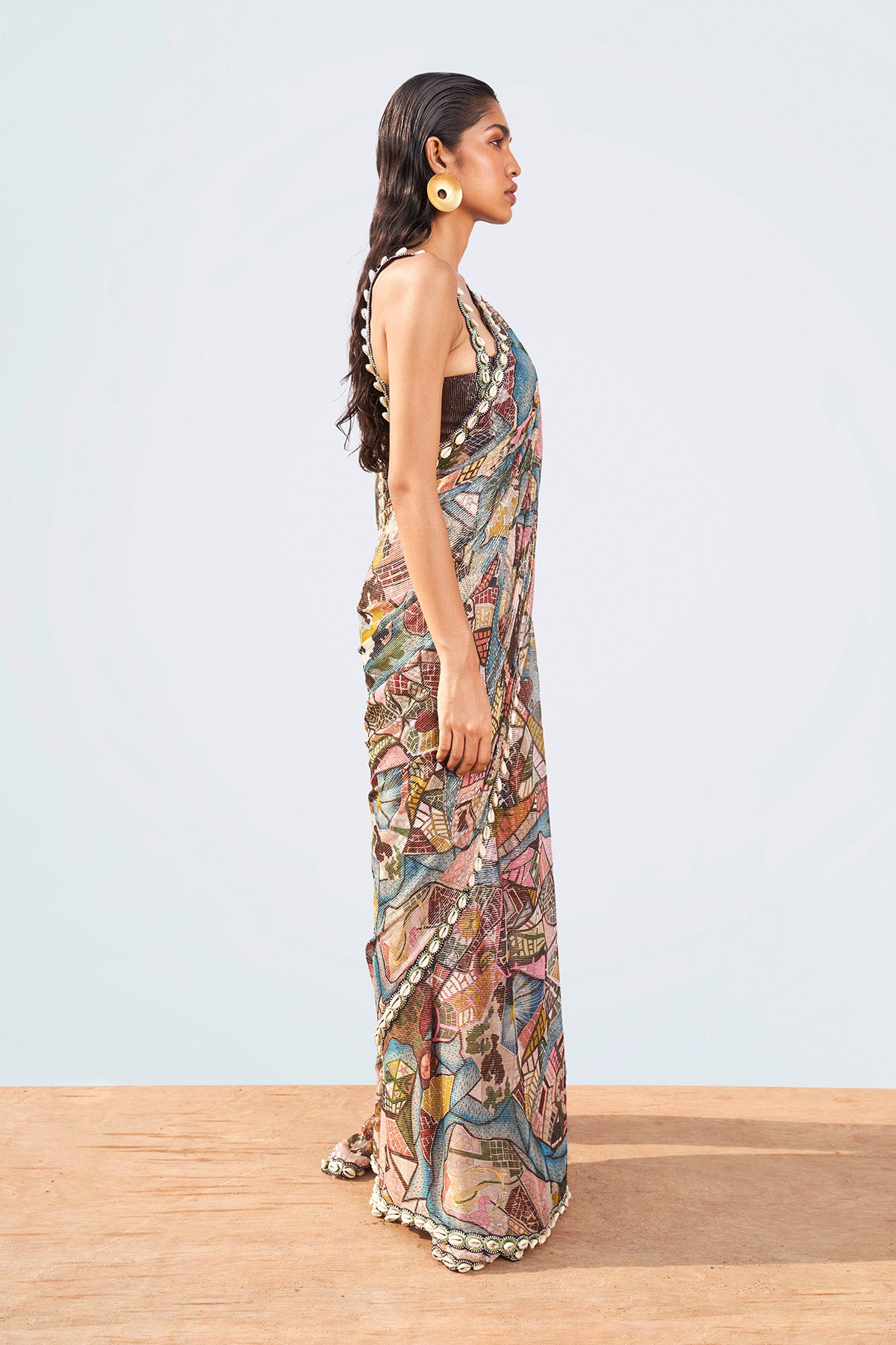 Left profile of multi-color printed saree and shell trim blouse.