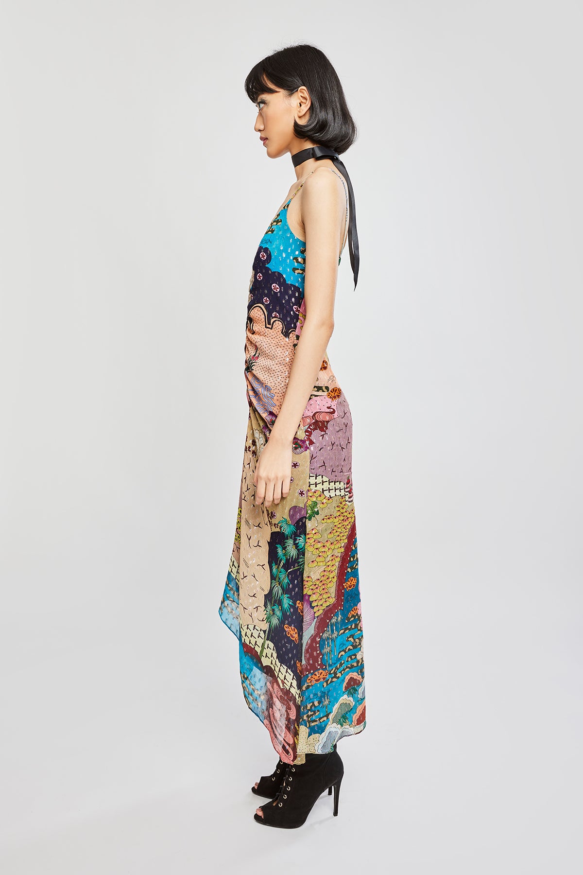 Side silhouette showing dress flow and ruched waist detail