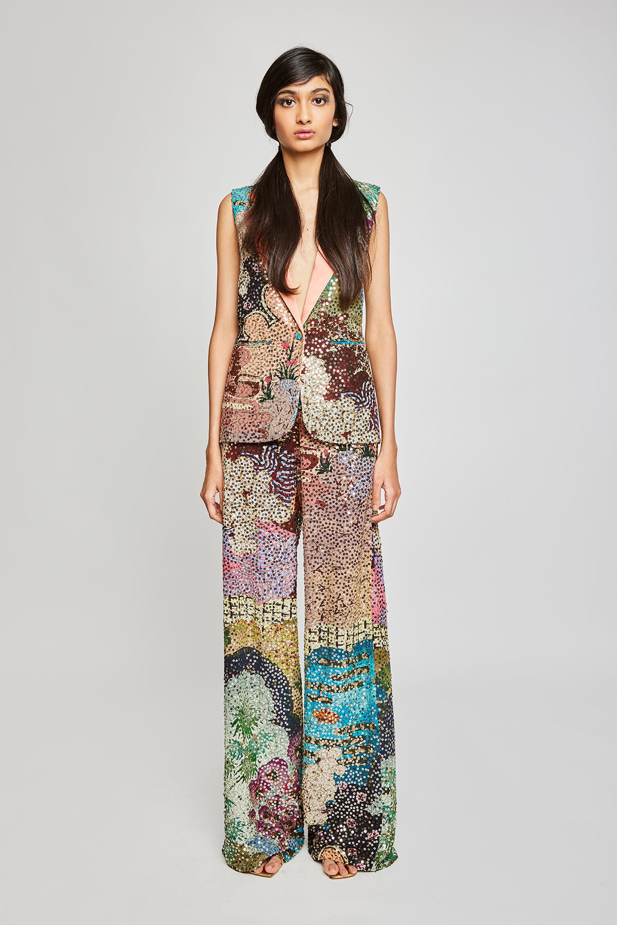 Front profile featuring the maze sequined sleeveless jacket paired with wide leg pants.