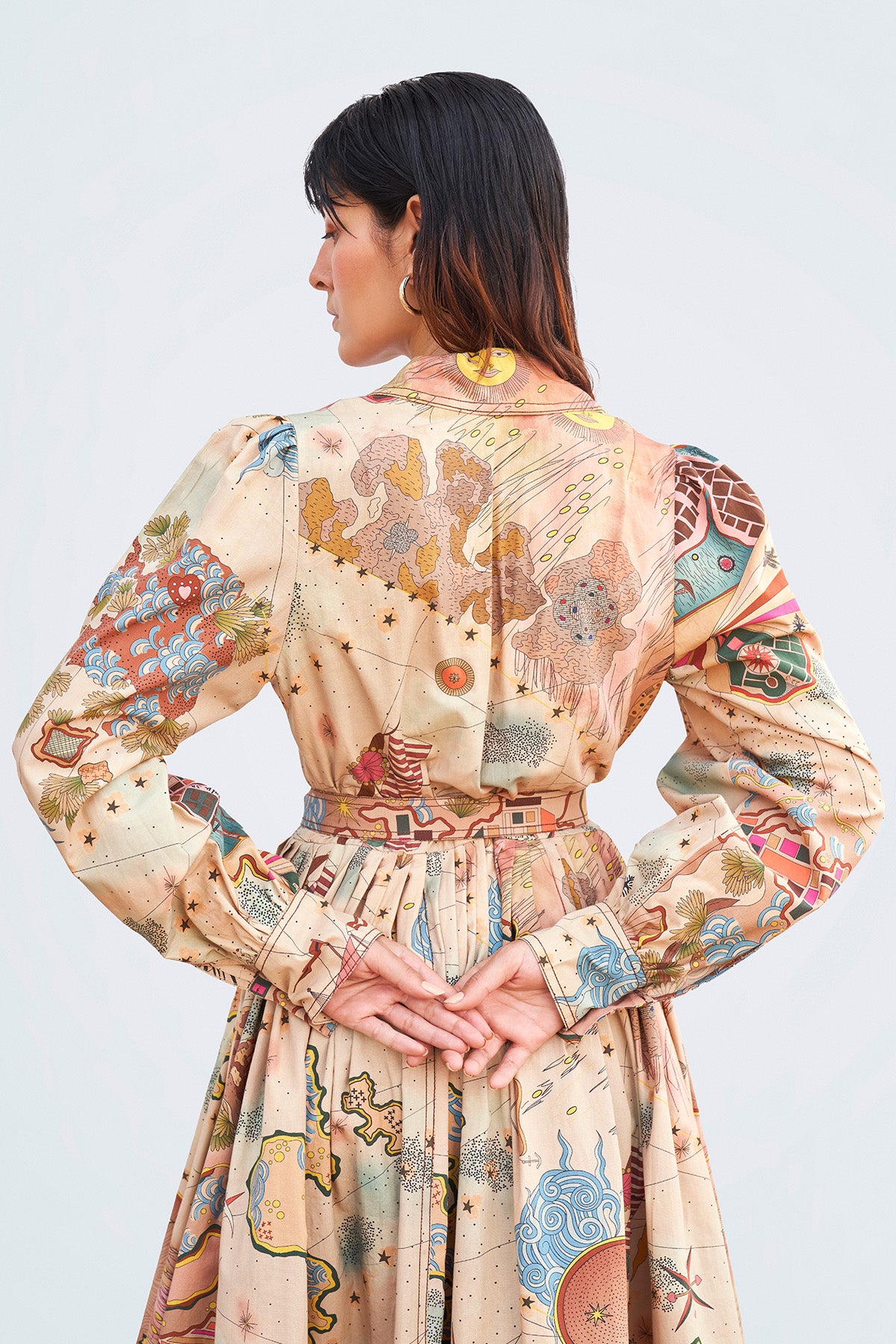 Close-up of collar, belt, and front flap detailing.