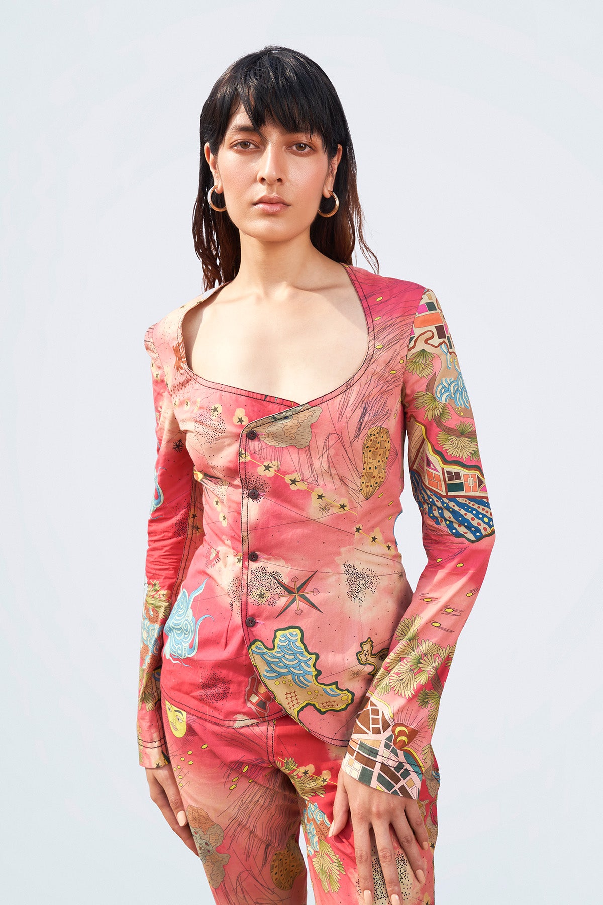 Close-up of print and fabric texture on blazer and pant front.