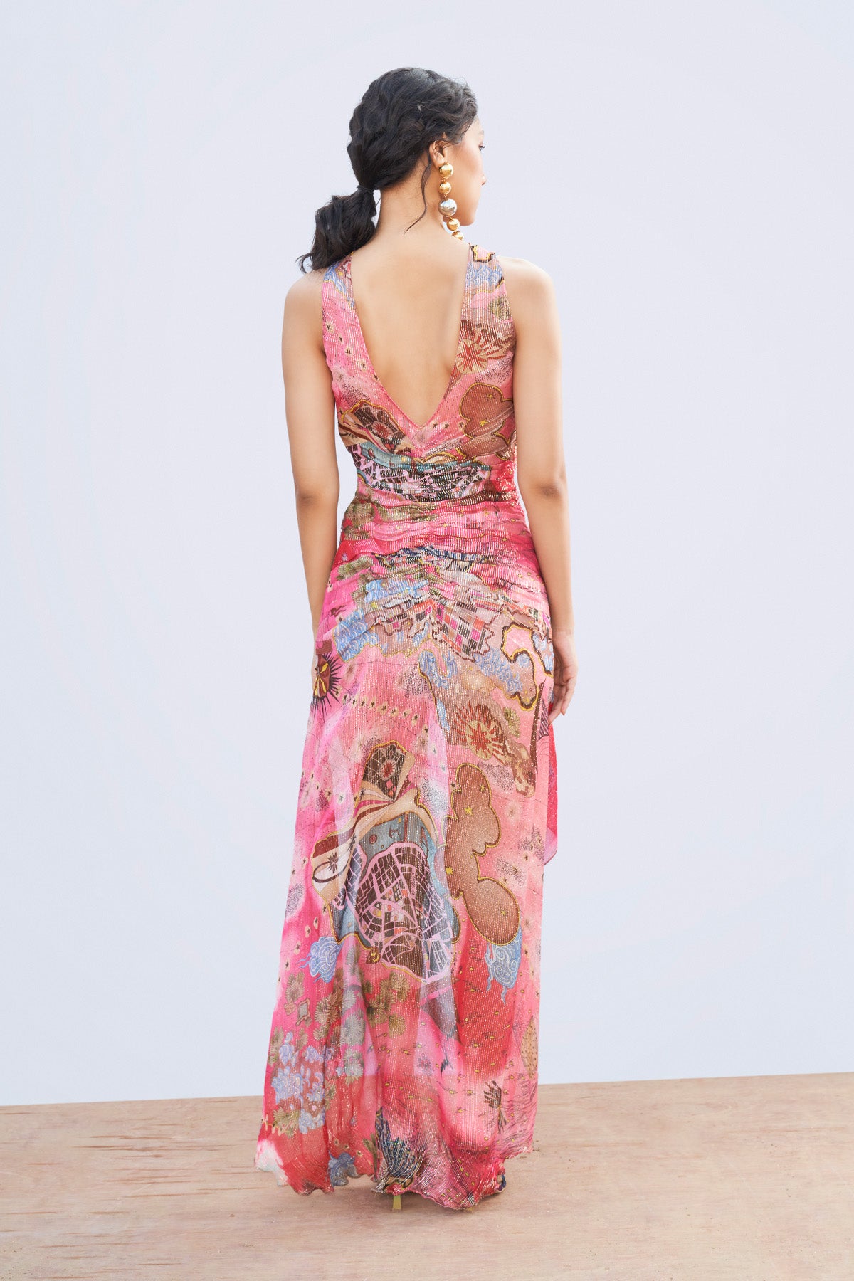 Right side view of printed gathered dress.