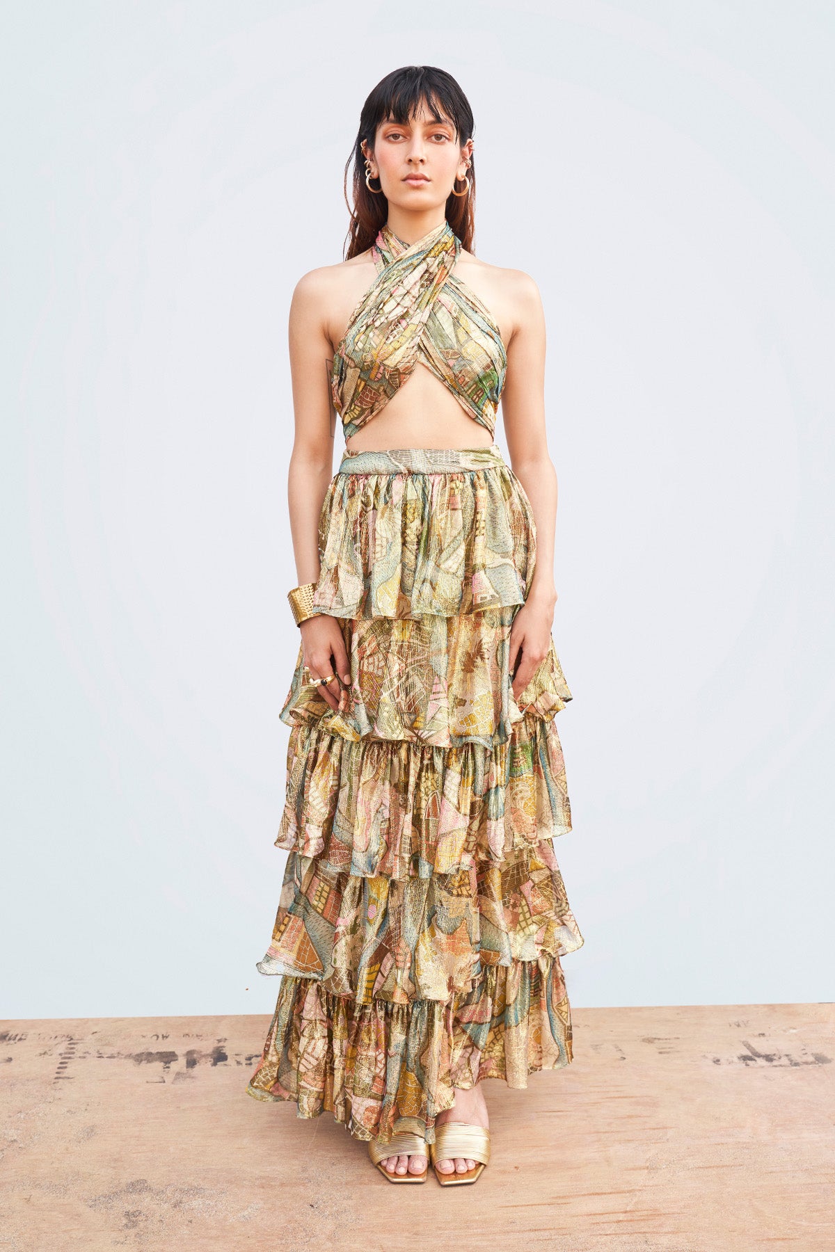 Front view of Starboard & Port gold twisted top with crossover halter neckline.