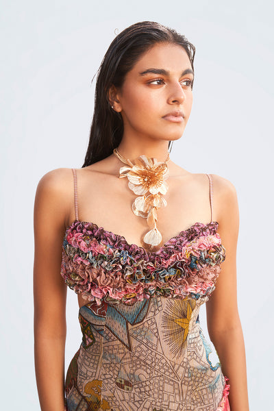 Close-up of ruffle trims and print on dress bodice.