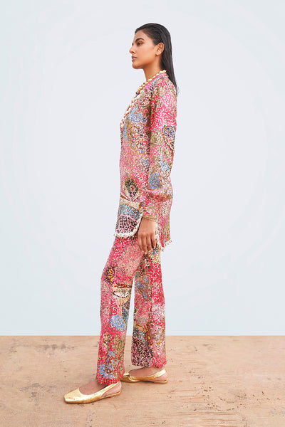 Close-up of sequin appliqué and shell trim on left tunic panel.

