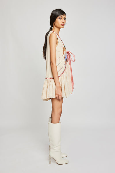  Close-up of front appliqué and embellishments on beige dress