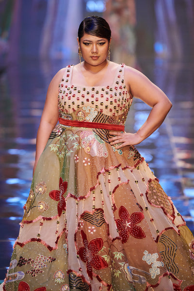 Close-up of embellishments and fabric texture on gown front.