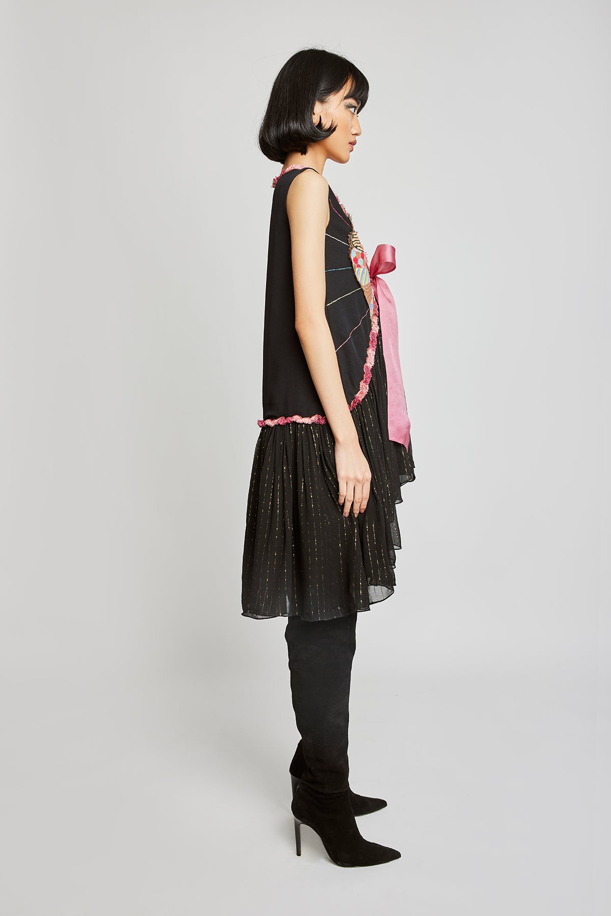 Close-up of front appliqué and bow-tie on black dobby dress