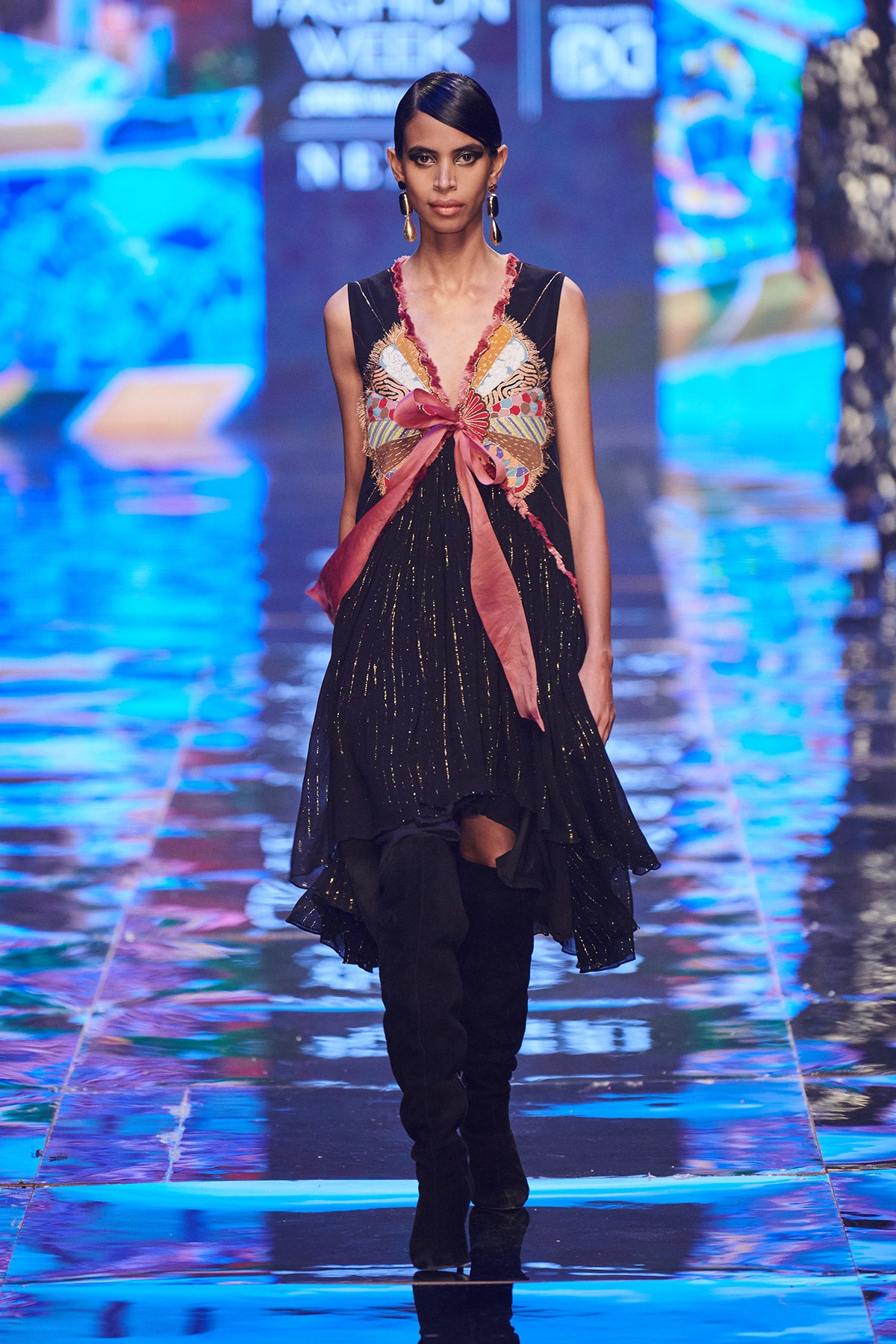 Right side view of Trencadís black dobby appliquéd dress with bow-tie detailing