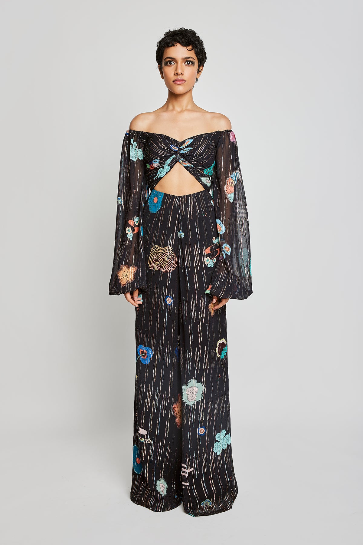 Front view of Trencadís black dobby jumpsuit with knot and puff sleeves