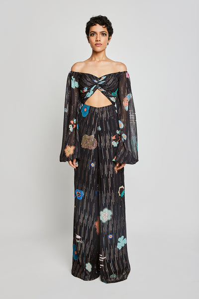 Front view of Trencadís black dobby jumpsuit with knot and puff sleeves