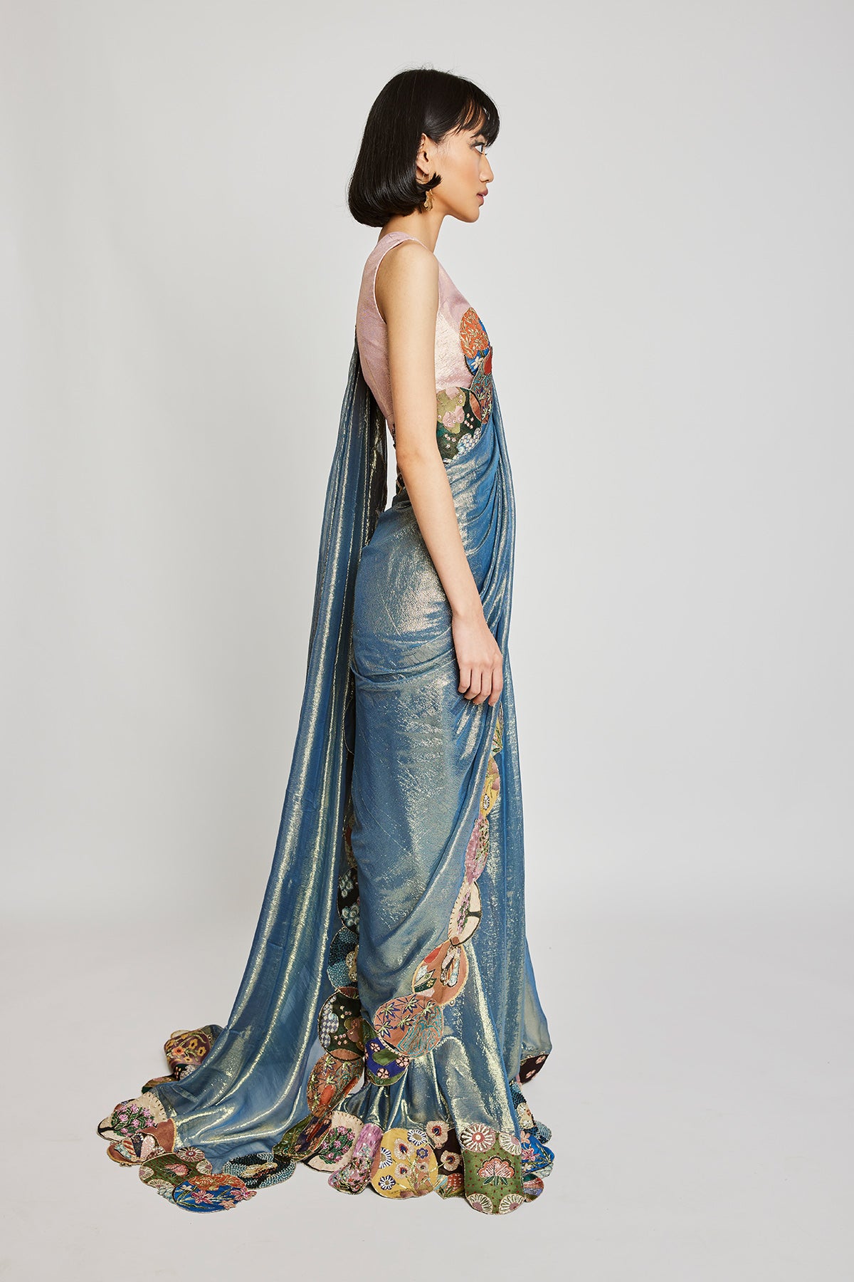 Left profile of blue dobby pre-draped saree and embroidered blouse.
