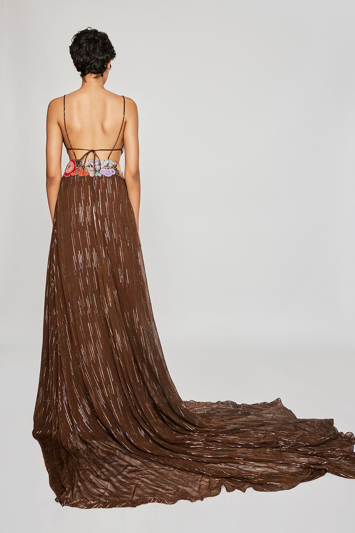 Close-up of the left side appliqué and embellishments on the Trencadís brown dobby trail gown