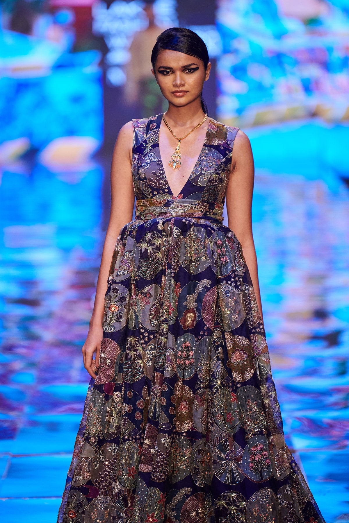 Close-up of embellishments and fabric texture on gown front.