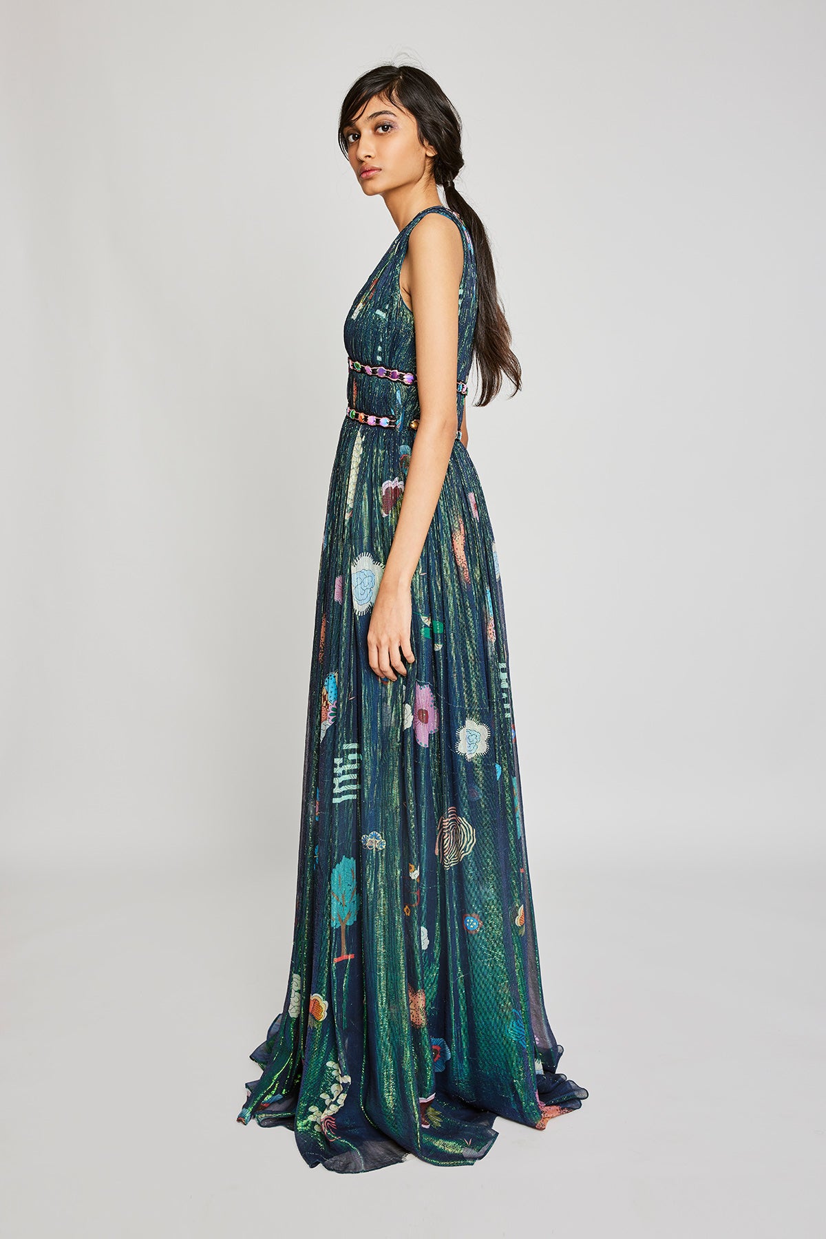 Left side view of the Trencadís green gown with ruched detailing