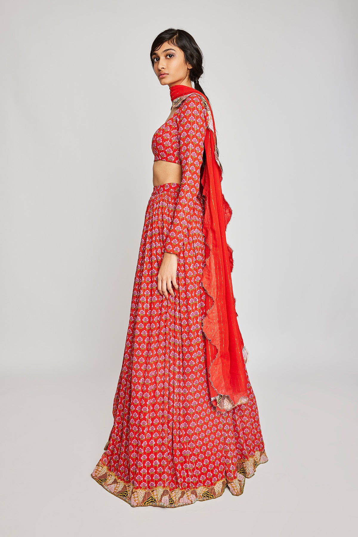  Left side view of the Trencadís red dobby embellished lehenga set