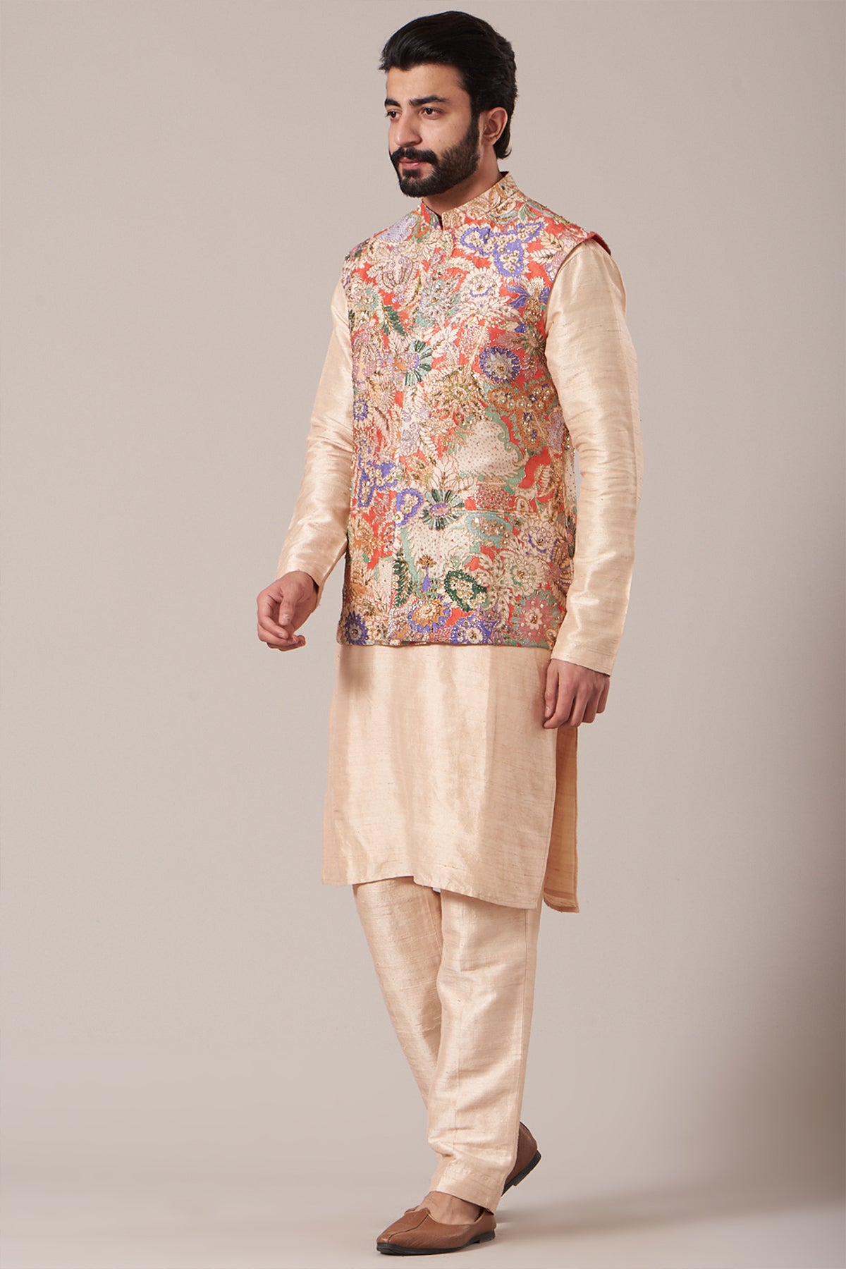 Left side view of red juna raw silk printed and embellished bundi with cream raw silk kurta and pants
