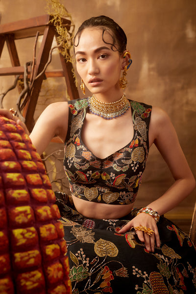 Close-up of front appliqué and embellishments on black lehenga set