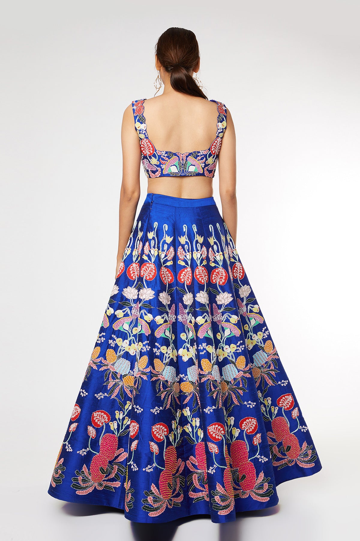 Back view of electric blue pastiche raw silk appliquéd lehenga with blouse and cutwork tulle dupatta