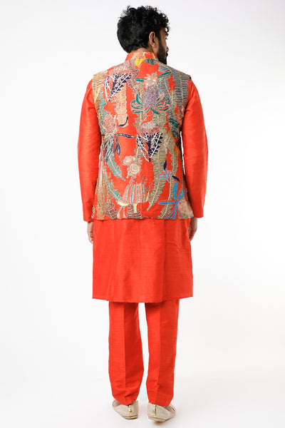 Back view of fiery red pastiche raw silk printed and embellished bundi with red raw silk kurta and pants