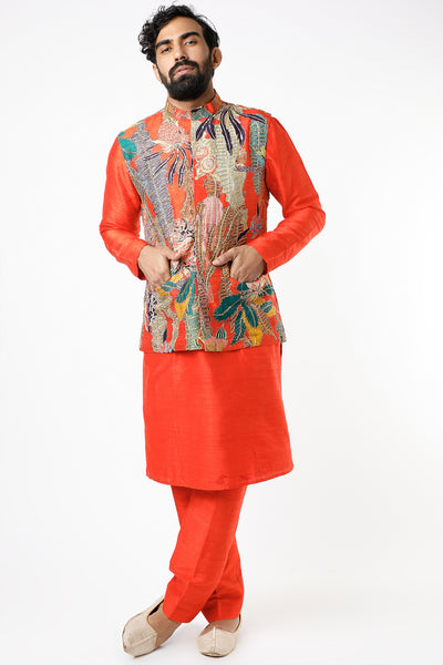 Front view of fiery red pastiche raw silk printed and embellished bundi with red raw silk kurta and pants