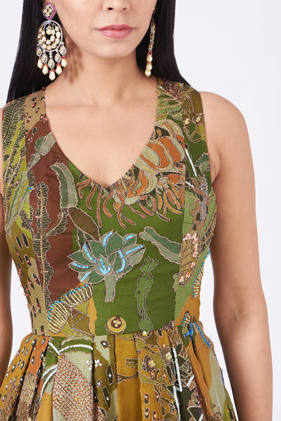 Close-up of front print and embellishments on olive green gown